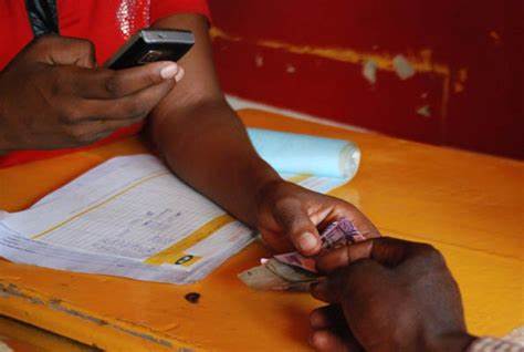  A Ugandan mobile money agent making transactions